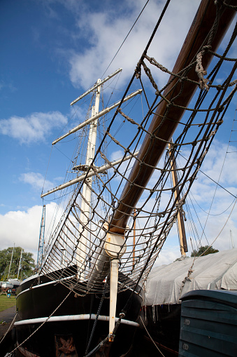 Bowsprit on large wooden sailing ship viewed from low angle