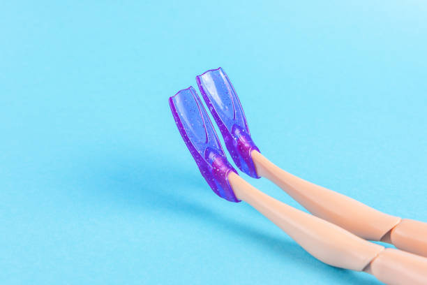istock Creative composition with doll legs and flippers on blue background. Minimal summer vacation concept. 1256105770