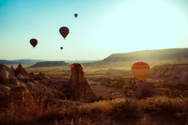 istock Hot air balloons floating in the sky at sunset 1256105927
