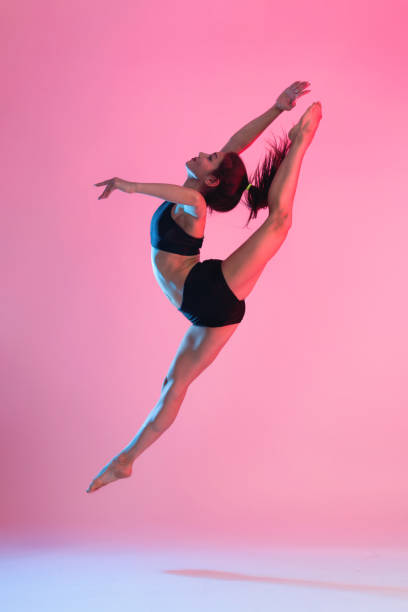 istock Young Gymnast Woman Jumping Up And Training 1256107189