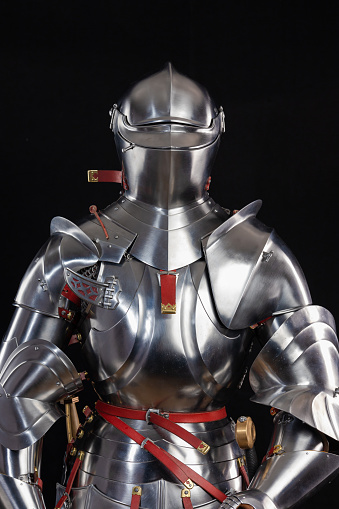 Medieval knightly armor, full set and details, made by an adult in full growth. Copy Milanese Armor Beauchamp. A copy was made in Belarus by Steel Legacy workshop, photographed on a black background in a studio.