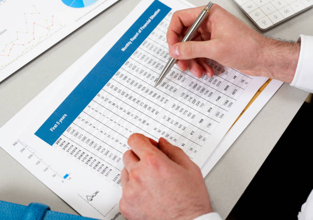 istock Man reviewing financial papers 1256107560