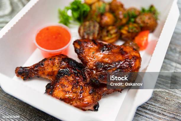 Caramelized Bbq Chicken Leg Quarters With Homemade Fried Potato Food To Go Stock Photo - Download Image Now