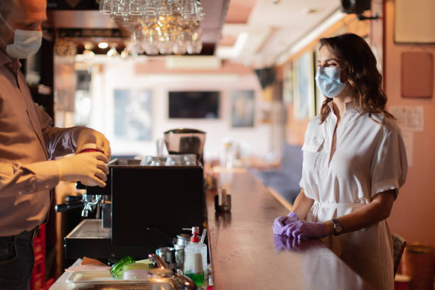 istock Wearing protective face mask and waiting for coffee to go at the bar 1256109042