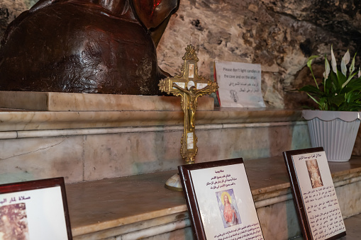 Haifa, Israel, July 10, 2020 : The golden crucifix stands in the main hall of the Stella Maris Monastery which is located on Mount Carmel in Haifa city in northern Israel