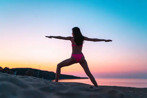 Beautiful free and woman on themedicine yoga asana balance energy day routine practice
