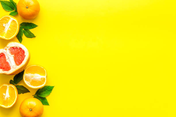 istock Oranges and grapefruits with leaves on table top view copy space 1256111679