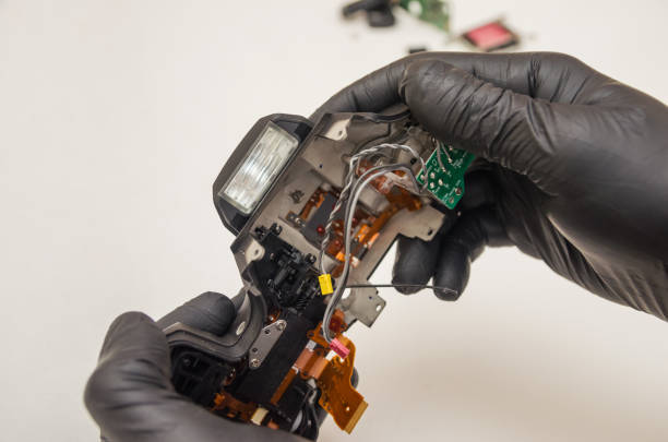 istock Disassembled camera body in the hands of the master 1256111755