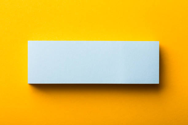 istock Blank Paper Isolated On Yellow Background 1256112261