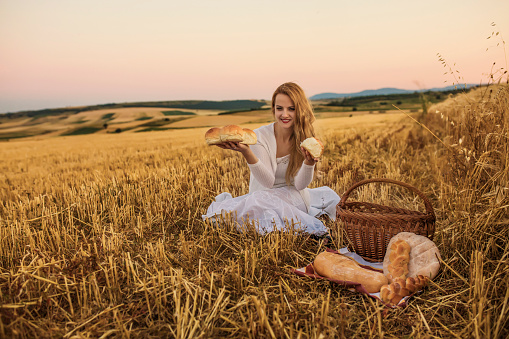 Blonde Young Woman in Golden Wheat Field