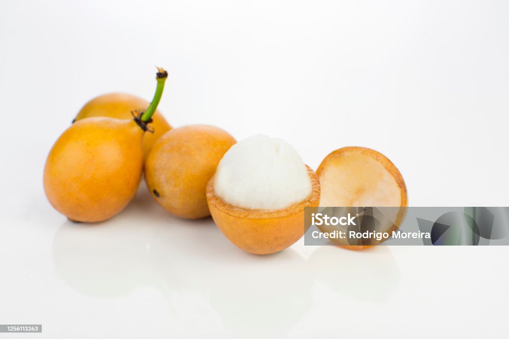 Open Bolivian exotic fruit called Achachairu isolated in white background Tropical Fruit Stock Photo
