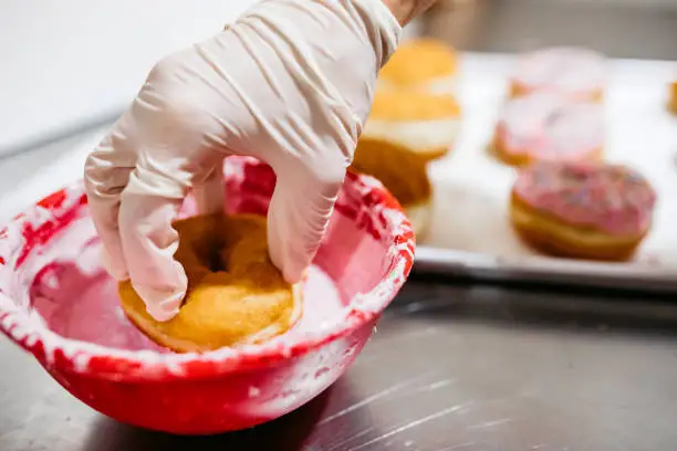 Photo of Putting donut in strawberry dipper