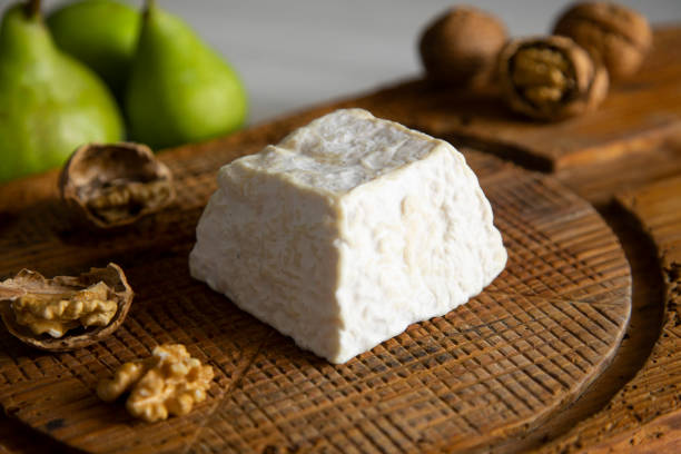 istock Premium organic goat cheese  on a rustic wooden cheese maker. 1256116817