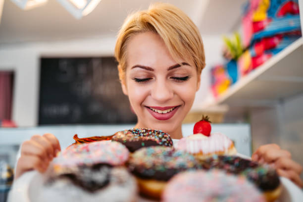 istock Woman looking at donuts at the bakery store 1256117457