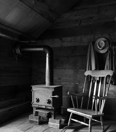 A room with a wood burning stove in a barn