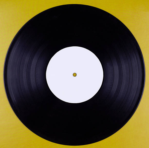 istock An old vinyl record with an empty label isolated against a mustard-colored background 1256119691