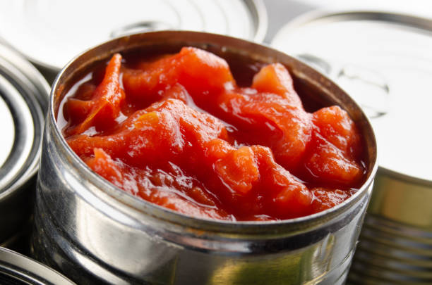 istock Canned sliced tomatoes in just opened tin can. Non-perishable food 1256121132
