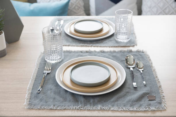 istock Table setting with yellow plate in modern style dining room at home. 1256121308