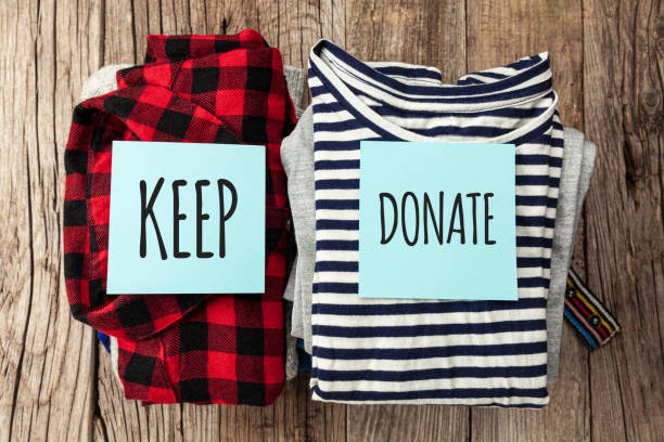 istock Stack of old clothes to discard (declutter) or keep. Recycle clothes, eco cotton 1256122315
