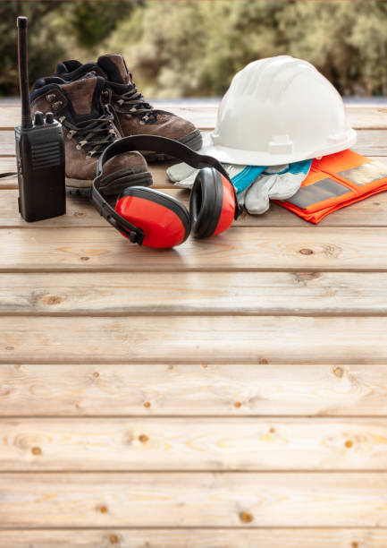 istock Work safety protection equipment. Industrial protective gear on wooden table, blur construction site background. 1256122911