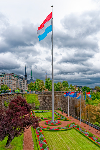 Luxembourg national flag in the park at Place de la Constitution, Luxembourg City. Luxembourg