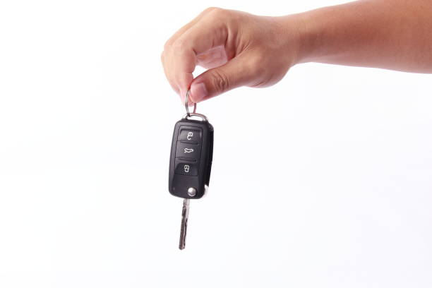 Man hand holding car key, isolated on white background
