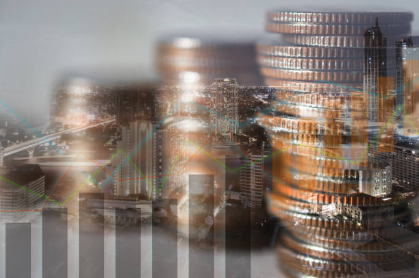 istock double exposure of city with row of coin stack with growth chart and graph progress report for business investment finance banking and money saving concept. 1256126924