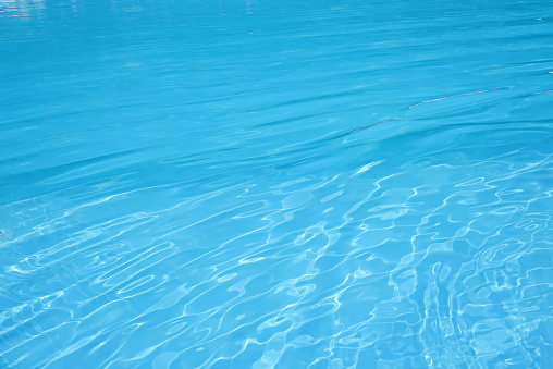 The surface of the water in the blue swimming pool.