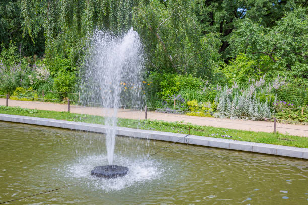 istock Small fountain in the summer green park 1256129544