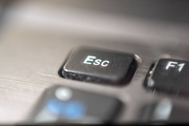 Detail of a plastic letter "Esc" on a laptop keyboard with shallow depth of field Detail of a plastic letter "Esc" on a laptop keyboard with shallow depth of field escape key escape computer push button stock pictures, royalty-free photos & images