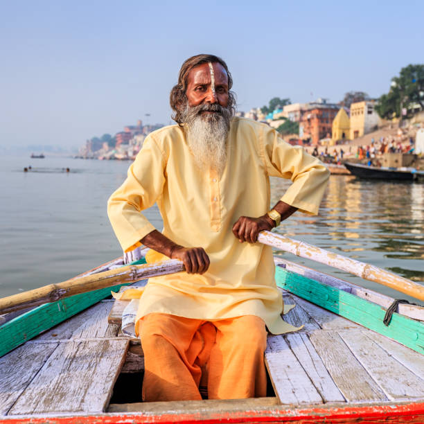 istock Sadhu rowing boat on the holy Ganges River in Varanasi 1256129993