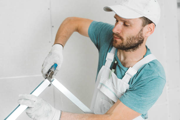 istock Caucasian worker on construction site assembling metal rods for drywall intallation 1256130938