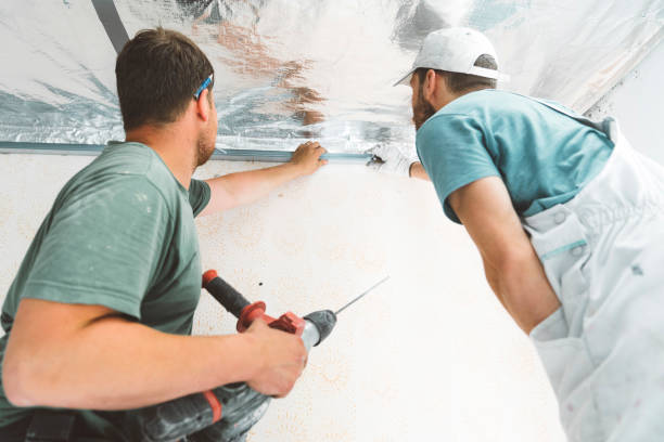 istock Two construction workers putting together a metal frame for the drywall 1256130946
