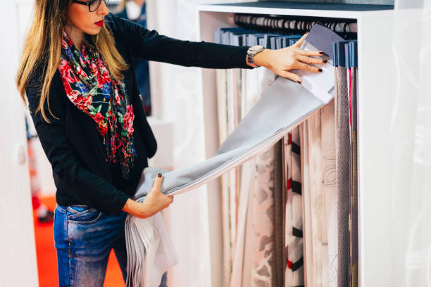 istock Woman Choosing Fabric At Store 1256131647