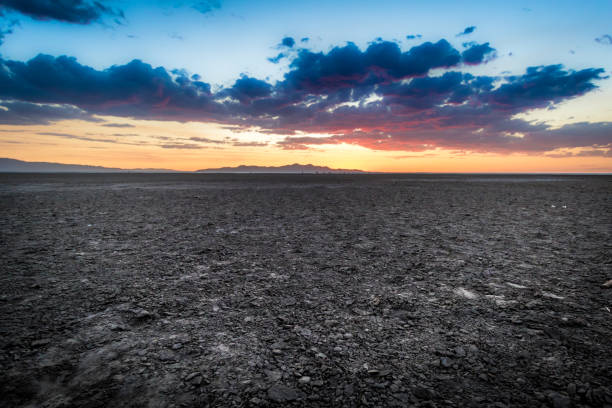 istock Colorful Sunset Over Rocky Flat Desert 1256132541
