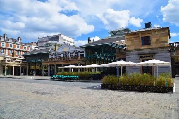 Exterior street view of the famous Covent Garden market, London, daytime with partly cloudy sky, July 2020