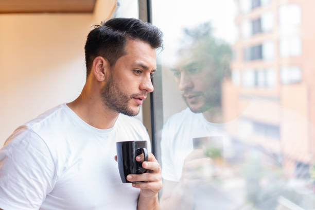 istock Latino man drinks coffee in the morning 1256134012