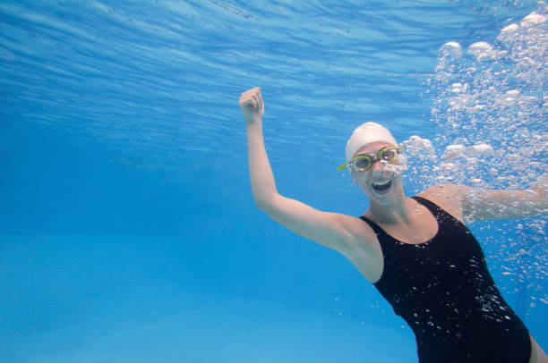 istock Woman Swimming In Pool 1256134045