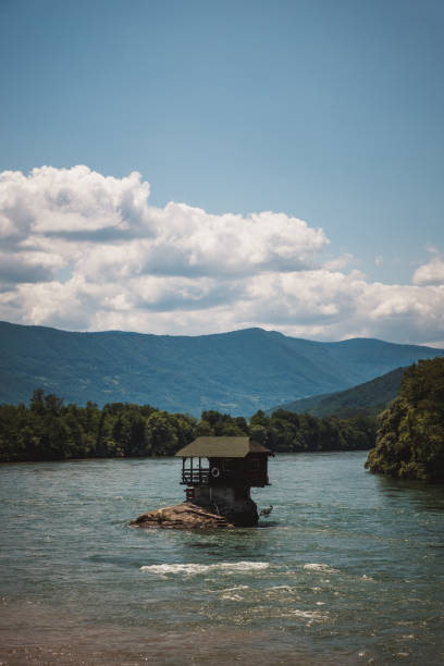 istock Drina river house on a rock with clouds behind 1256137021