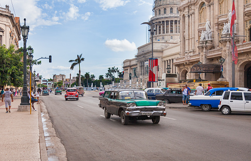 Havana, Cuba-October 07, 2016. Common and popular for tourist, busy street with classic, old style, American cars and people next to the historical, famous Great Theatre at old part of Havana City in Cuba on October 07 2016.