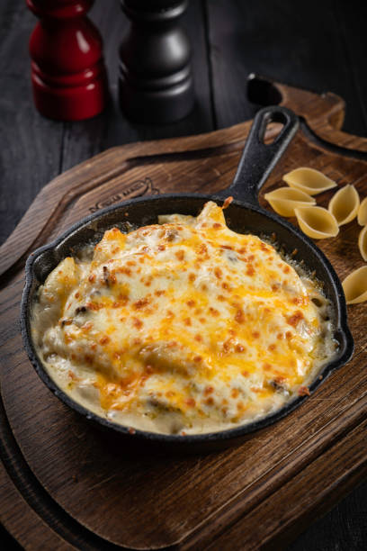 istock Pasta with cheese and chicken on a black background 1256138513