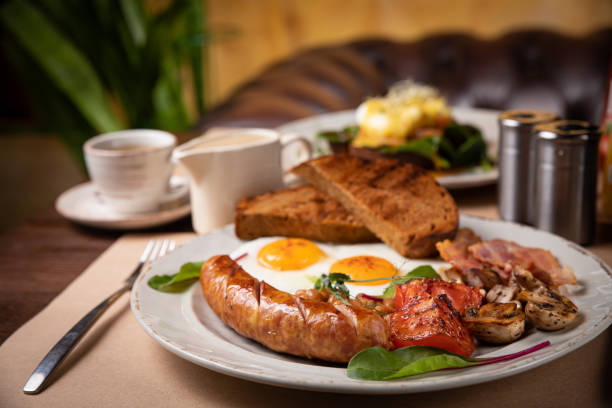 istock Full English breakfast - fried egg, baked beans, bacon, sausages 1256139358
