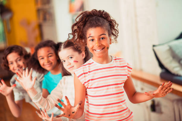 istock Joyful kids playing with watercolors during the art class 1256139367