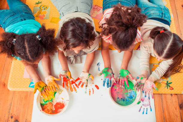 istock Children painting with their hands during the art class 1256139376