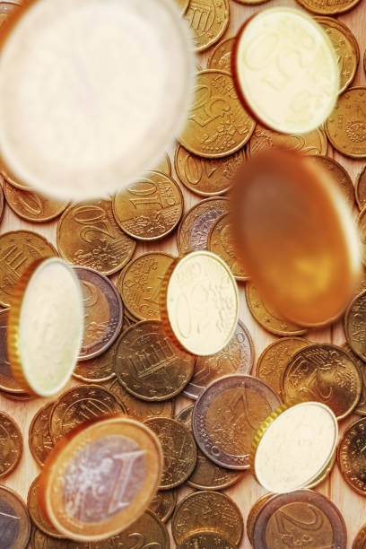 istock Business concept with Euro coins falling from above 1256140261