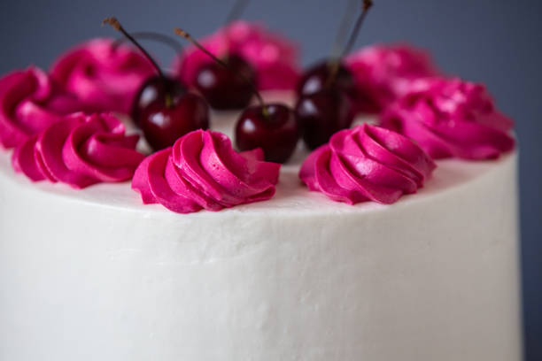 istock White Cream Icing Cake with Fruits, on blue background 1256142888