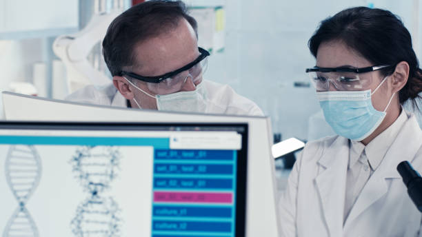 istock Genetic research laboratory interior.  Multi ethnic team during biohazardous tests 1256144250