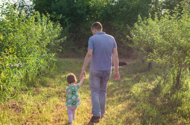 istock The family walks in the orchard 1256144818