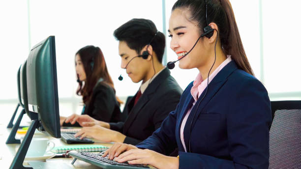 istock Business people wearing headset working in office 1256146498