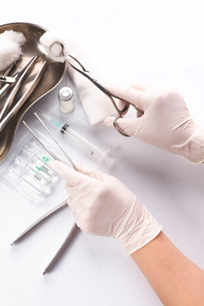 istock Close up hand dentist is selecting a tool used to treat patient teeth. 1256147521